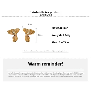 Detail view of large gold-tone petal earrings with measurements 8.6x5cm and silver pins