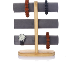 Detailed view of 3-tier bamboo jewelry stand with grey velvet watch and bracelet holders