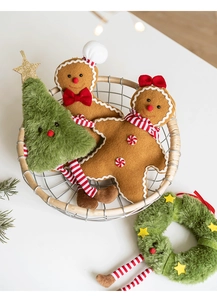 Detail of plush gingerbread man and Christmas tree ornaments in a woven basket