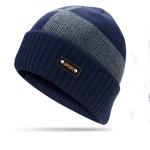Detailed shot of dark blue knit beanie with gray stripe and leather SPORT tag