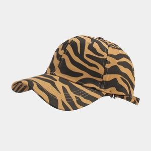 Detail view of the zebra animal print pattern and stitching on a curved baseball cap