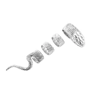 Detail of silver snake rings set featuring vintage punk style and scaly scale texture