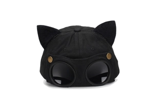 Detail of creative black cat ear baseball cap with integrated pilot goggles and metal buttons