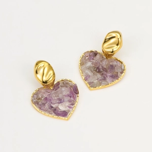 Close-up of 18K gold earrings with heart-shaped natural purple stone inlays