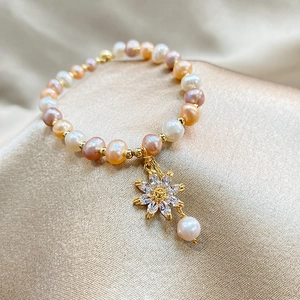 Elegant multi-color freshwater pearl bracelet with a sparkling zircon sunflower charm