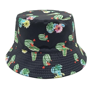 Close-up of cactus and floral print patterns on a black canvas bucket hat with stitching