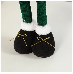 Detail of plush Christmas doll boots in black with white fur trim and golden bow