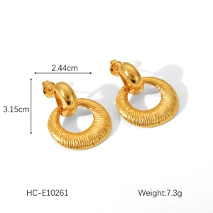 Detail view of gold hammered texture stainless steel earrings with dimensions 3.15cm by 2.44cm