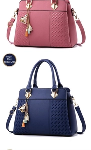 Detail of woven texture, gold metal hardware, and tassel charm on leather handbags