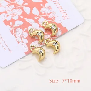 Macro shot of 7x10mm gold moon pendant charms with clear rhinestone for DIY jewelry