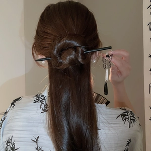 Detail of vintage butterfly hair pin with black water drop tassel on elegant updo