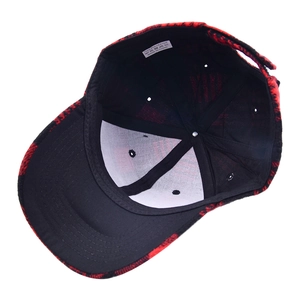 Detail view of red plaid baseball cap interior with black lining and 100% polyester label