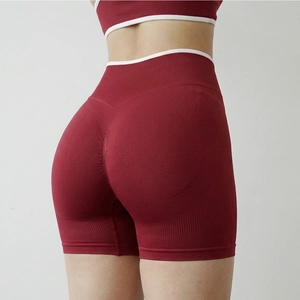 Close-up of burgundy high-waist yoga shorts with white contrast trim and scrunch butt detail