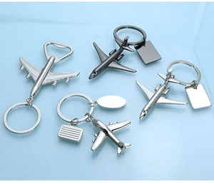 Detail of silver zinc alloy airplane keychains with built-in bottle opener and travel tags
