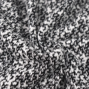 Macro shot of black and white knit texture showing fine yarn weaving details