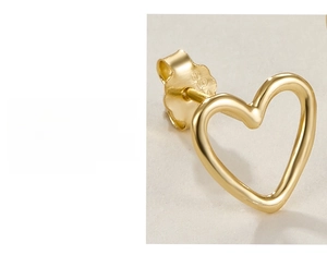 Detailed close-up of hollow gold-plated heart stud earrings with secure butterfly backs