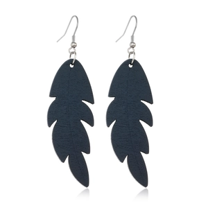 Detail of dark blue feather-shaped wooden earrings with silver hooks on white background