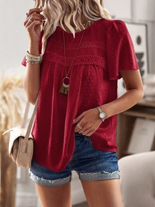 Detail of dark red short-sleeve top with polka dot texture and lace collar decoration