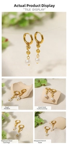 Macro detail of 18K gold plated titanium earrings with elegant round pearl pendants