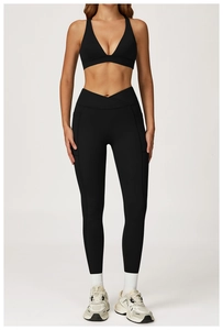 Detail of high-waisted crossover yoga leggings with side pockets in black set