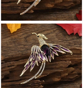 Close-up of a phoenix brooch featuring purple gemstones and sparkling crystal feathers