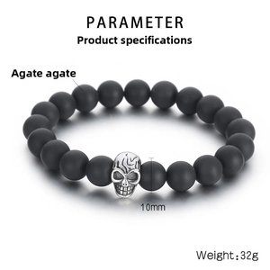 Macro view of 10mm matte agate beads and titanium steel skull charm on stretch bracelet