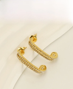 Detailed view of gold-plated double-layered stainless steel earrings with white zircons
