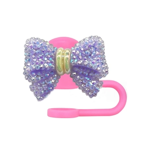 Pink silicone straw cover with purple rhinestone bow and gold ring for 10mm tumblers