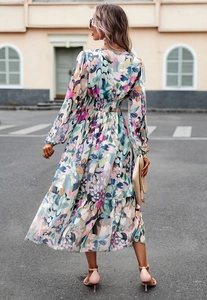 Macro shot of colorful floral print fabric and cinched waist on this flowy long dress