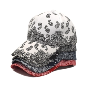 Stack of paisley pattern baseball caps in black, white, navy and red street style