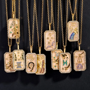 Gold zodiac sign necklaces with colorful birthstones and engraved symbols on a dark background