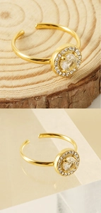Detail of 18K gold-plated double-layer ring featuring a central sparkling zircon stone