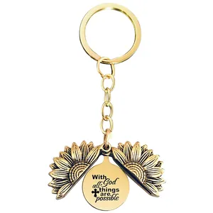 Detail of sunflower locket keychain with 'With all God things are possible' engraving