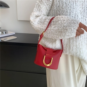 Fashionable red leather shoulder bag for women with polished gold buckle and adjustable strap
