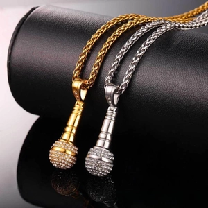Detail of hip hop microphone pendants in gold and silver with sparkling crystal pavé