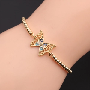 Detail of copper gold butterfly bracelet with multi-color zircon inlay on female wrist