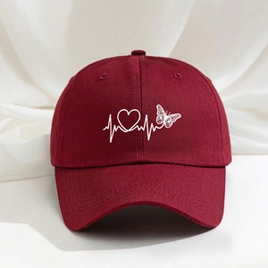 Detailed close-up of embroidered heart and butterfly on dark red cotton baseball cap