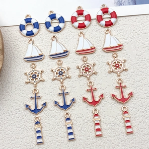 Detailed view of assorted nautical enamel charms including anchors and sailboats