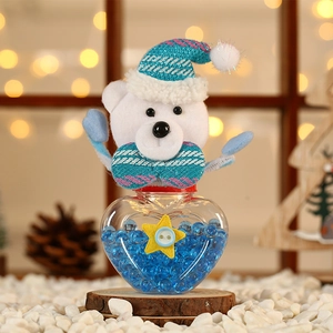 Close-up of heart-shaped Christmas candy jar with blue beads and a plush bear lid