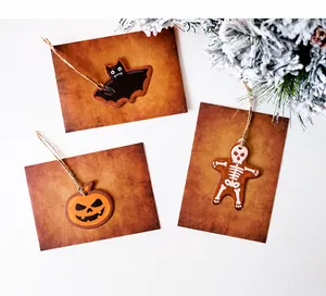 Detail of vintage Halloween gift tags with pumpkin, bat, and skeleton designs on twine