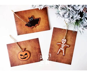 Detail of vintage Halloween gift tags with pumpkin, bat, and skeleton designs on twine