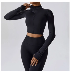 Detail of black sports yoga set featuring thumb holes on sleeves and high waist leggings