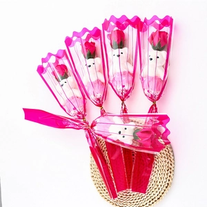 Soap rose bouquets with plush teddy bears in pink wrapping paper for teacher gifts