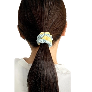 Minimalist two-tone scrunchie in light blue and yellow fabric for ponytail styling