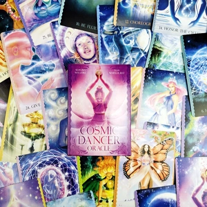 Cosmic Dancer Oracle cards detail featuring artistic spiritual illustrations and guidebook