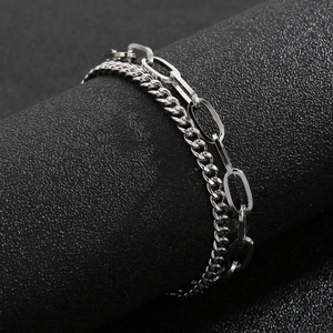 Detailed macro shot of silver double-layered metal cuban and link chain bracelet