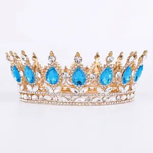 Golden bridal crown with teardrop blue gemstones and white zircons for weddings