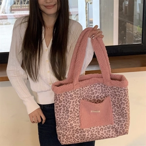 Detail of pink leopard print plush tote bag with front pocket and soft texture