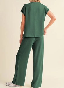 Rear view of dark green knitted loungewear set featuring short sleeves and wide leg pants
