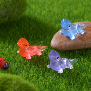 Luminous resin dinosaur miniatures on green moss for DIY micro landscape garden decor